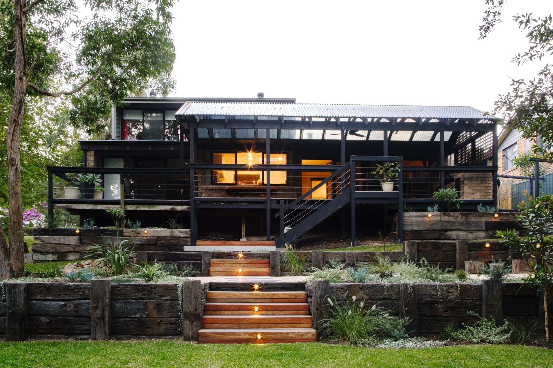 Terraced back yard with recycled timber beams and lighted walkway