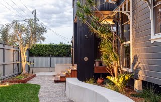 Backyard garden path with white concrete bench